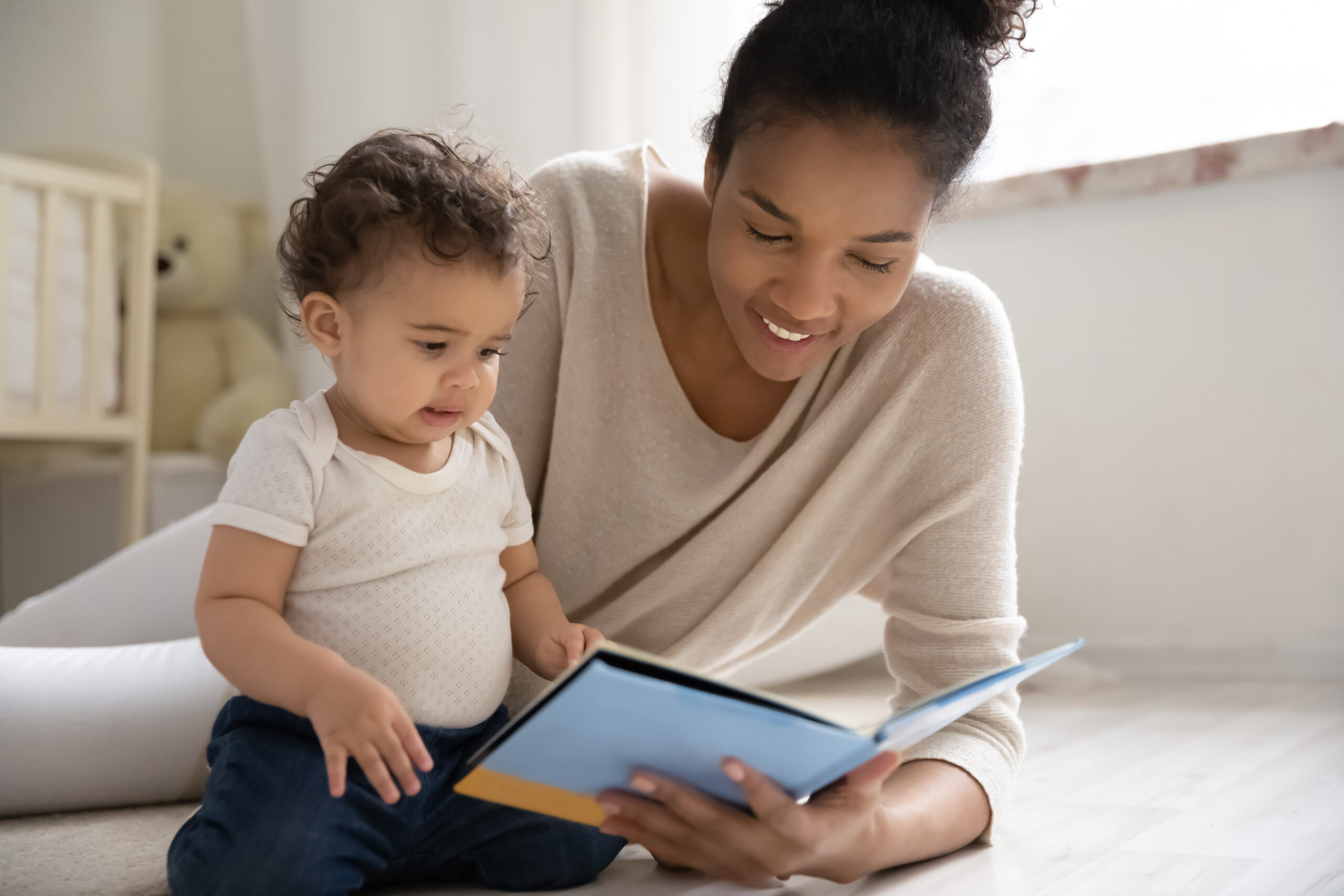 Mother with a baby looking at a book