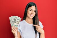 young woman with money from sugar dating