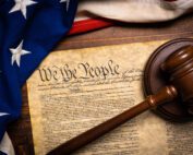 The United States Constitution with a US Flag and a gavel, showing its power