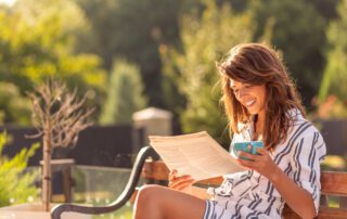 woman reading a newspaper of solutions journalism