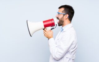 What does the science say? Man in white lab coat with megaphone,